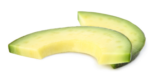 Slices of tasty ripe avocado on white background