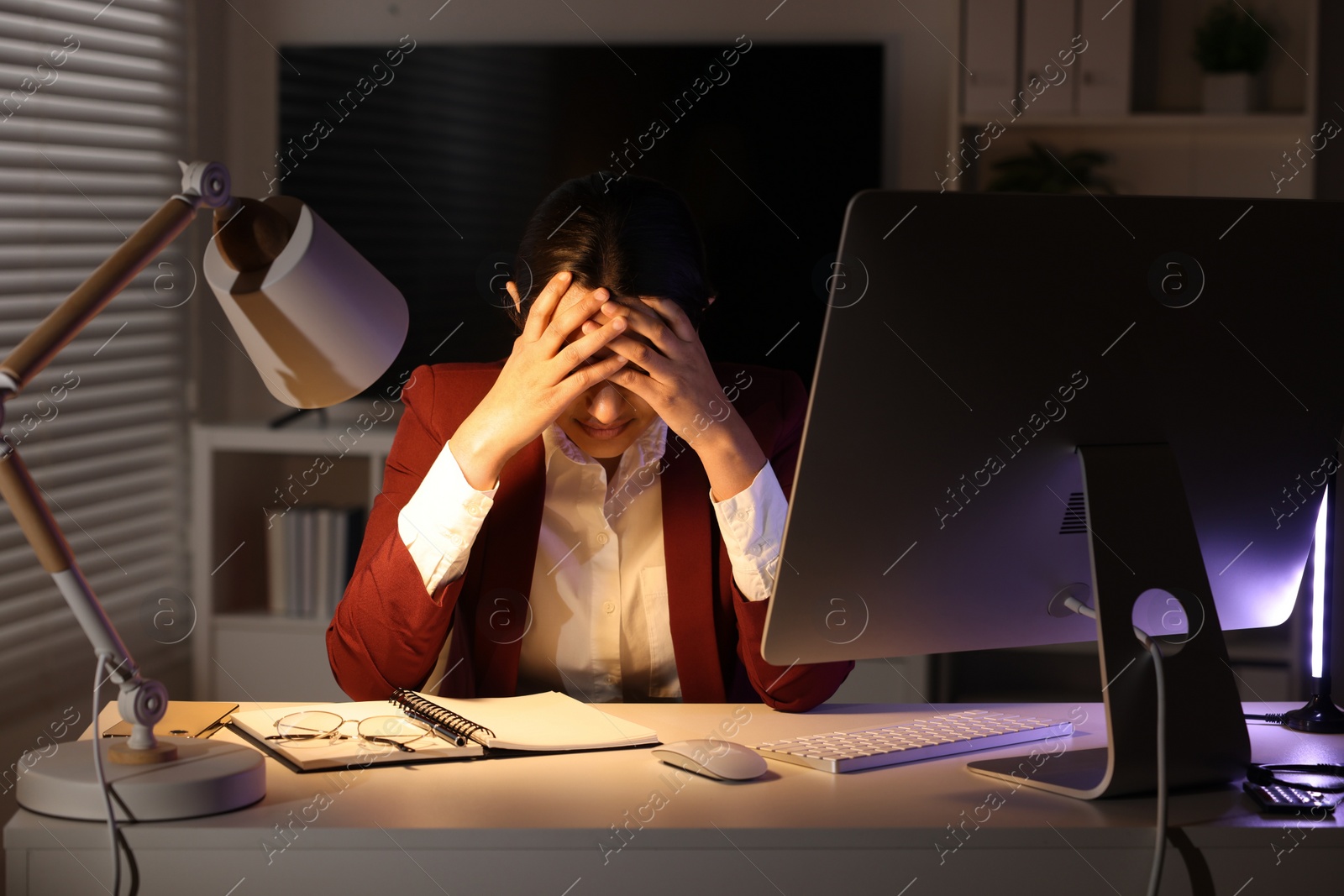 Photo of Tired overworked businesswoman at table in office