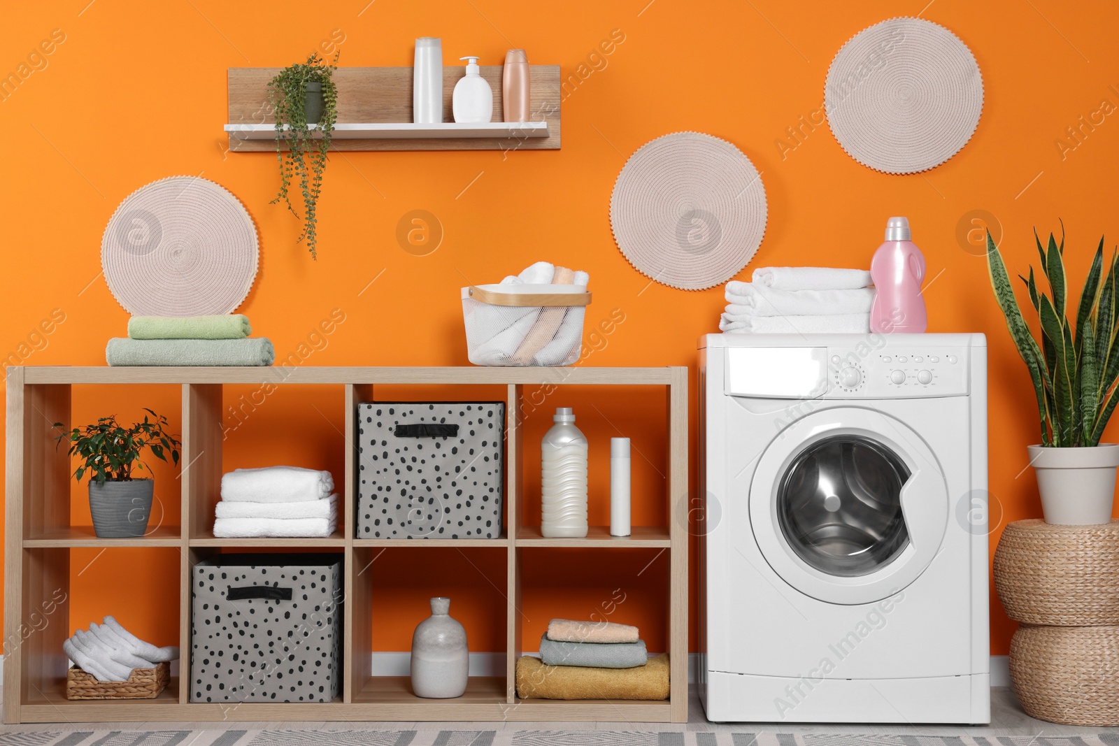 Photo of Stylish laundry room with washing machine. Interior design