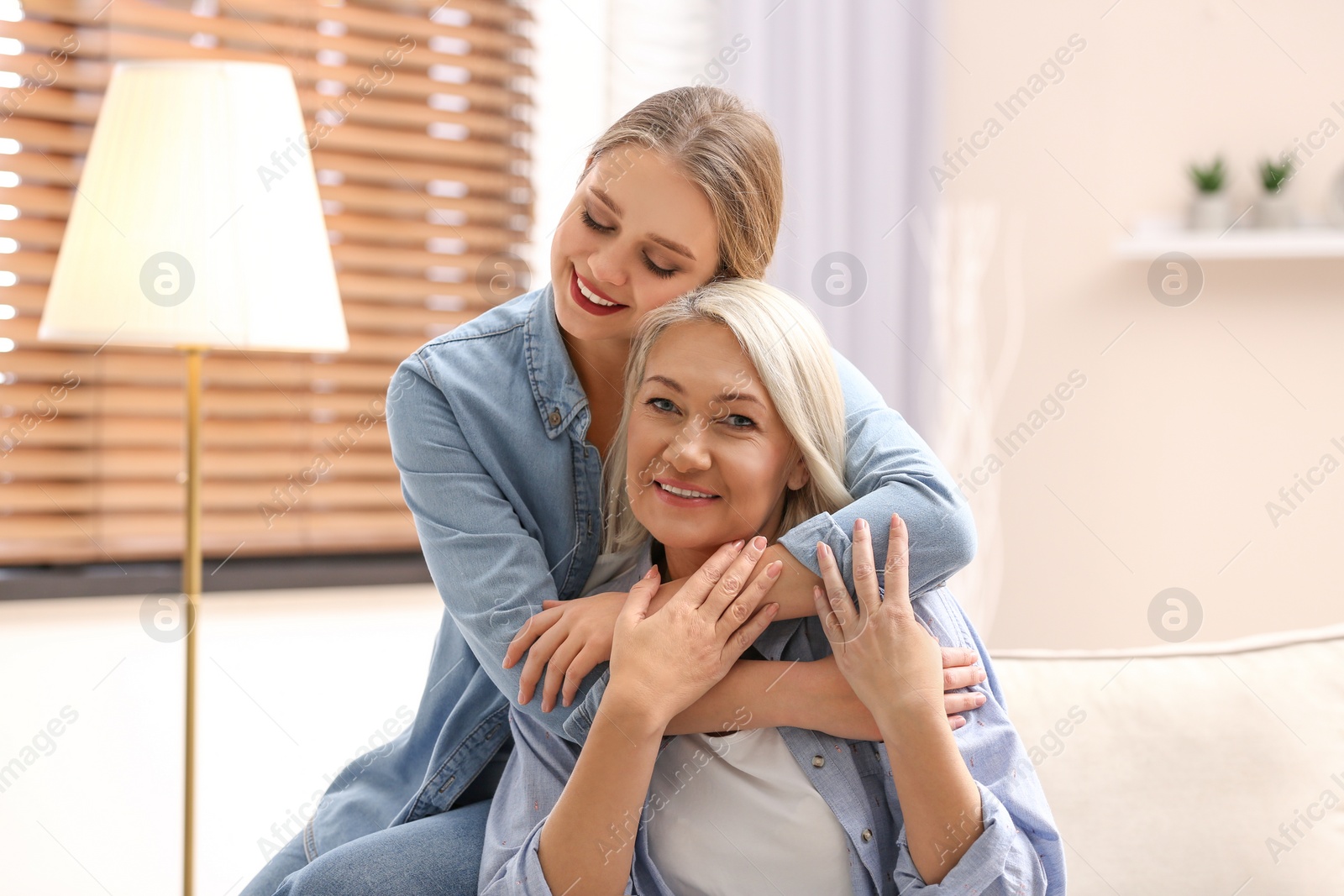 Photo of Mother and her adult daughter spending time together at home