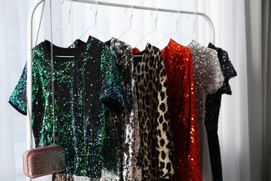 Photo of Rack with collection of beautiful festive clothes indoors