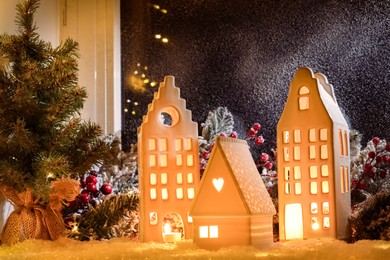 House shaped lanterns and Christmas decor on windowsill indoors