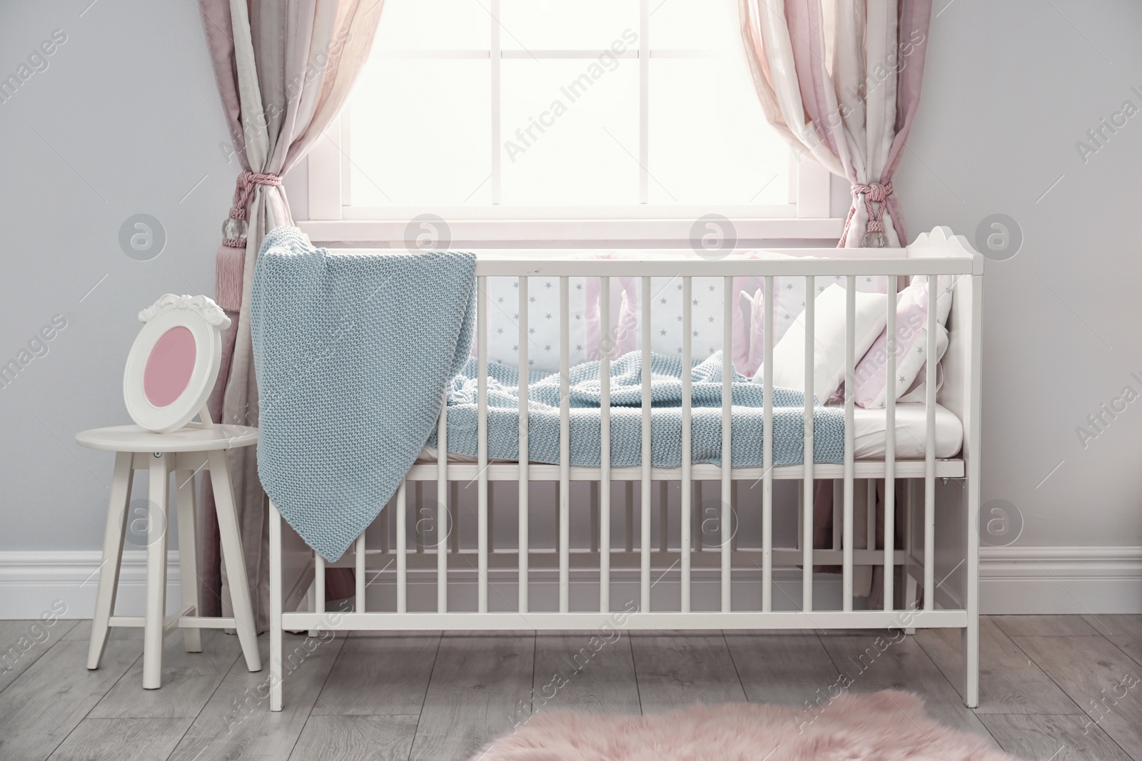 Photo of Baby room interior with comfortable crib