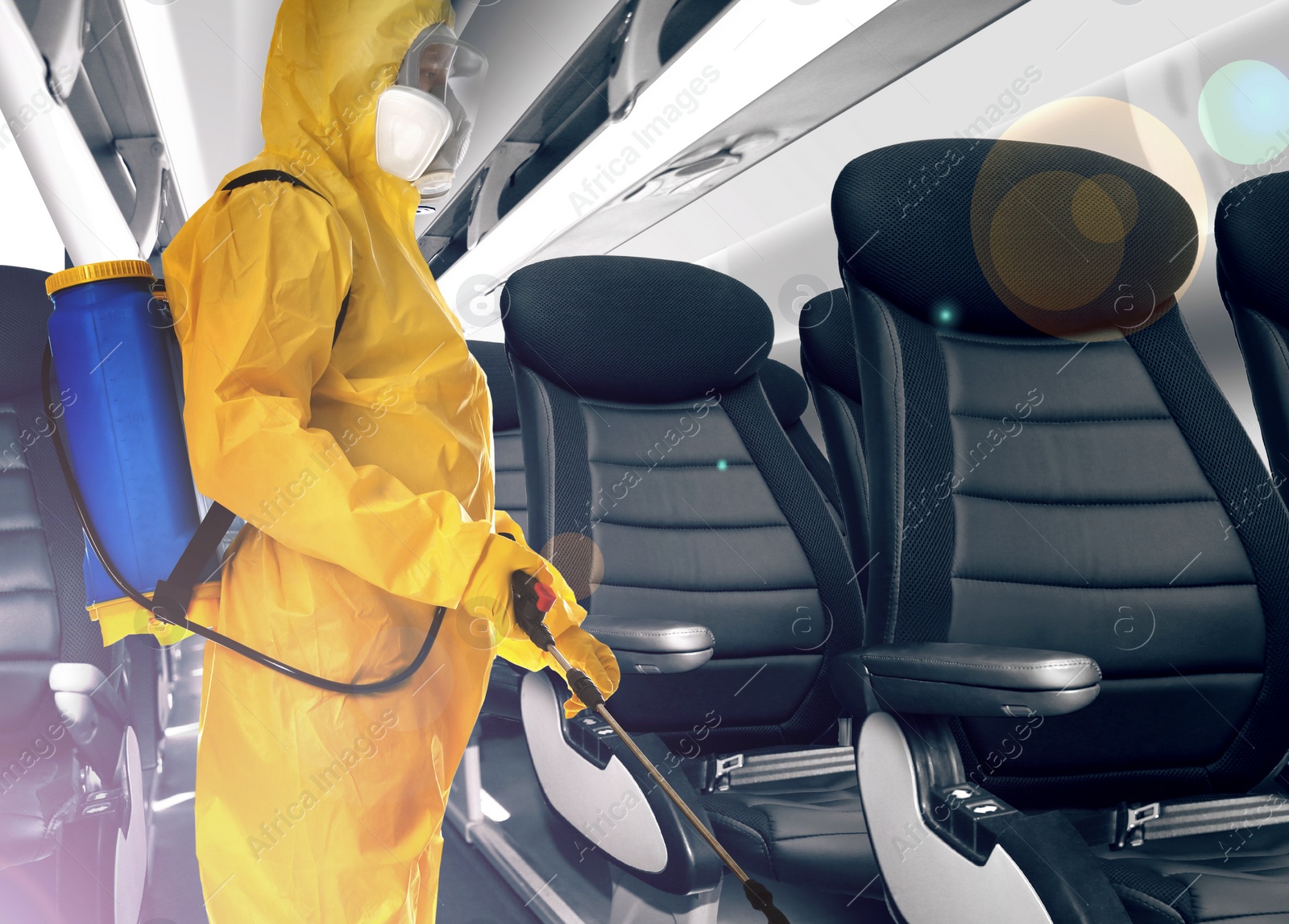 Image of Man wearing protective suit cleaning cabin in airplane to prevent spreading of Coronavirus