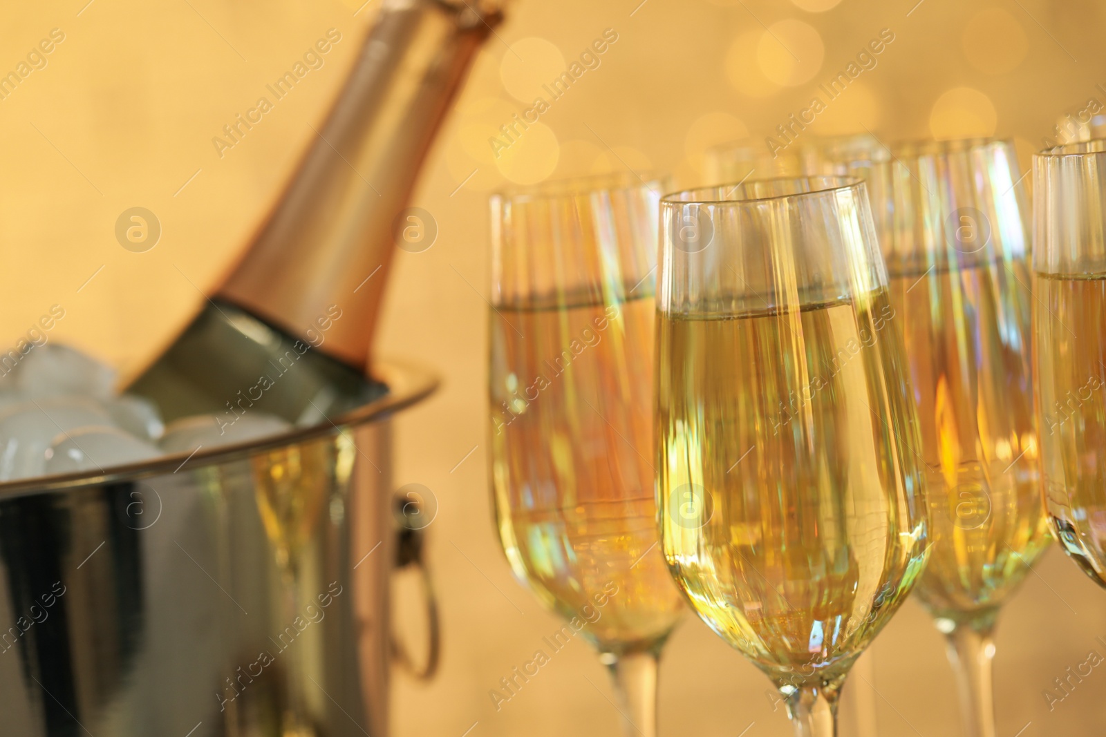 Photo of Glasses of champagne against blurred lights, closeup