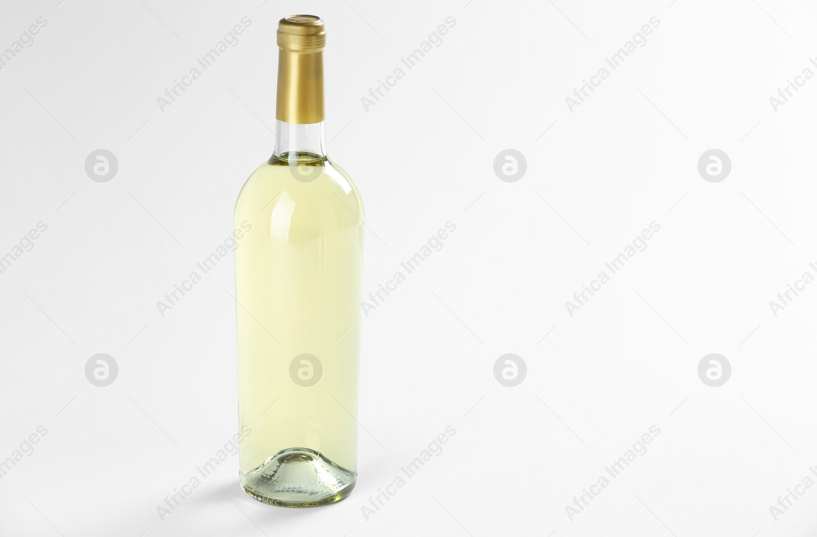 Photo of Bottle of expensive white wine on light background. Space for text