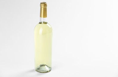 Photo of Bottle of expensive white wine on light background. Space for text