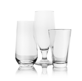 Set of empty glasses for different drinks on white background