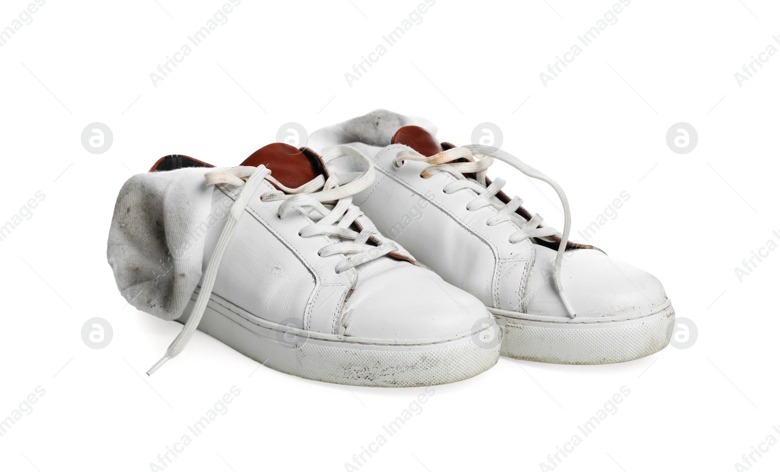 Photo of Dirty socks and sneakers on white background