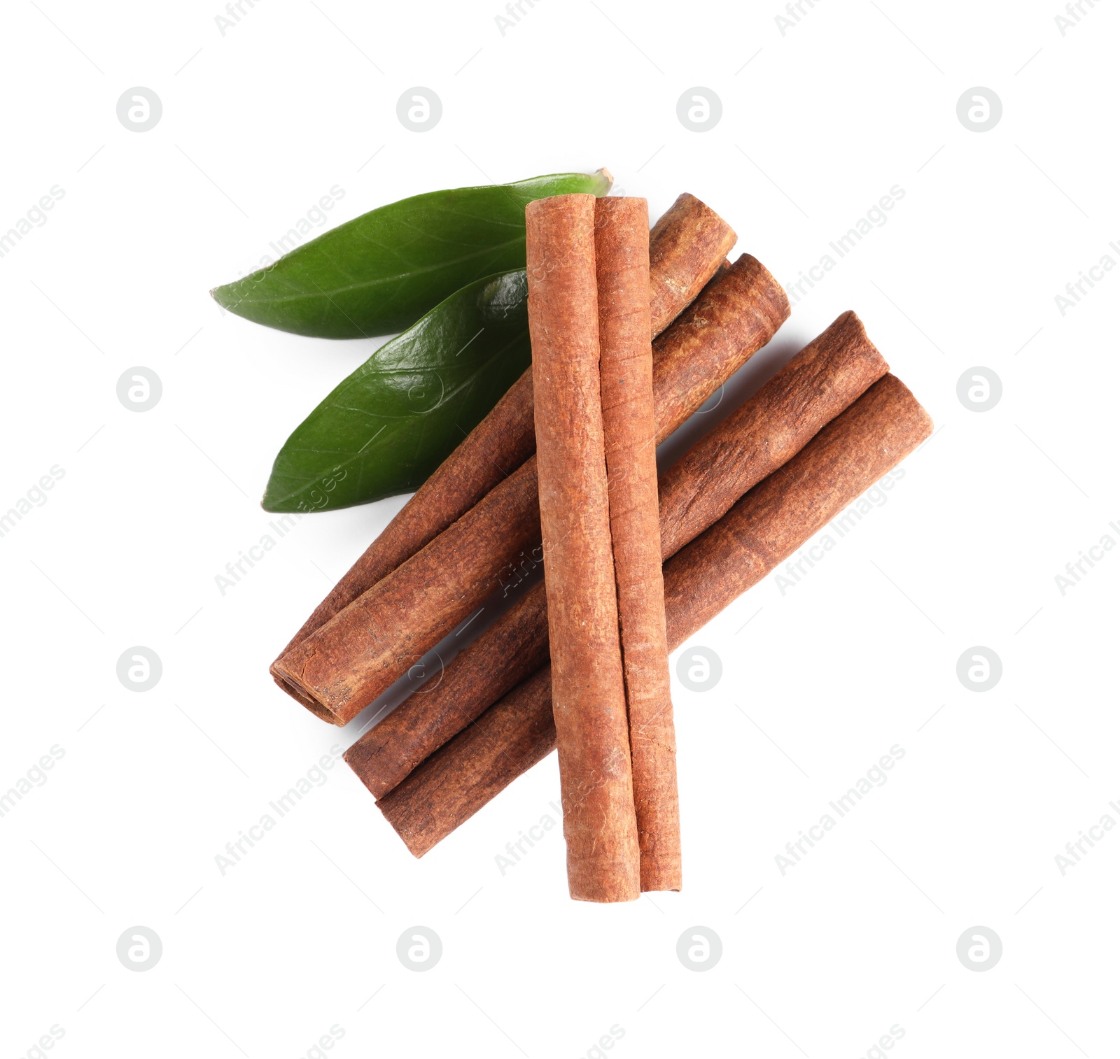 Photo of Cinnamon sticks and green leaves isolated on white, top view