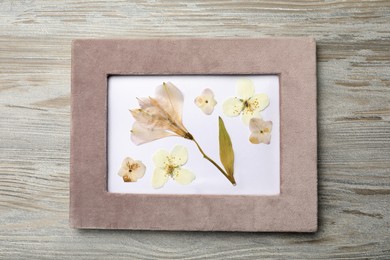 Photo of Beautiful herbarium with pressed dried flowers on white wooden table, top view