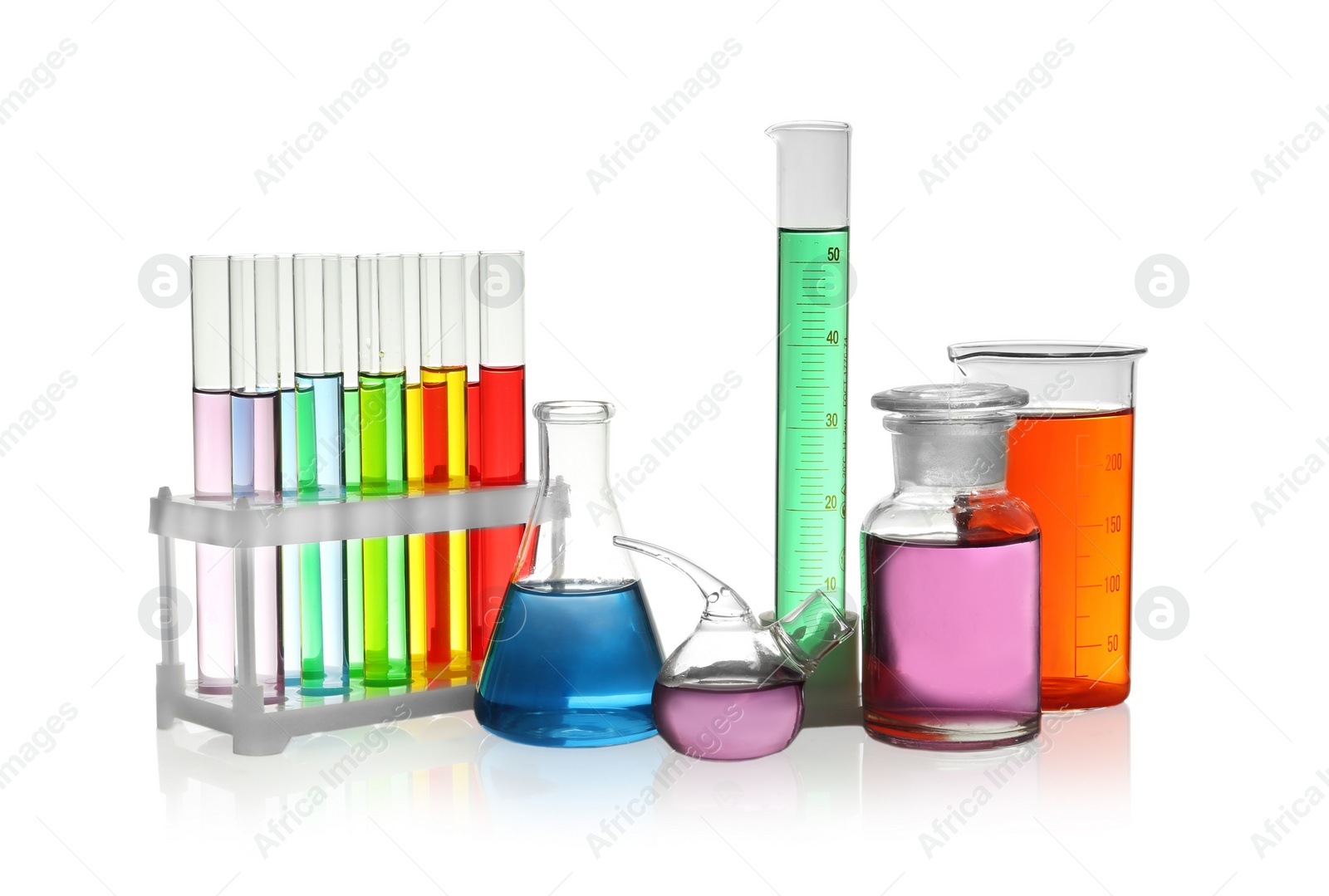 Photo of Laboratory glassware with colorful liquids on white background