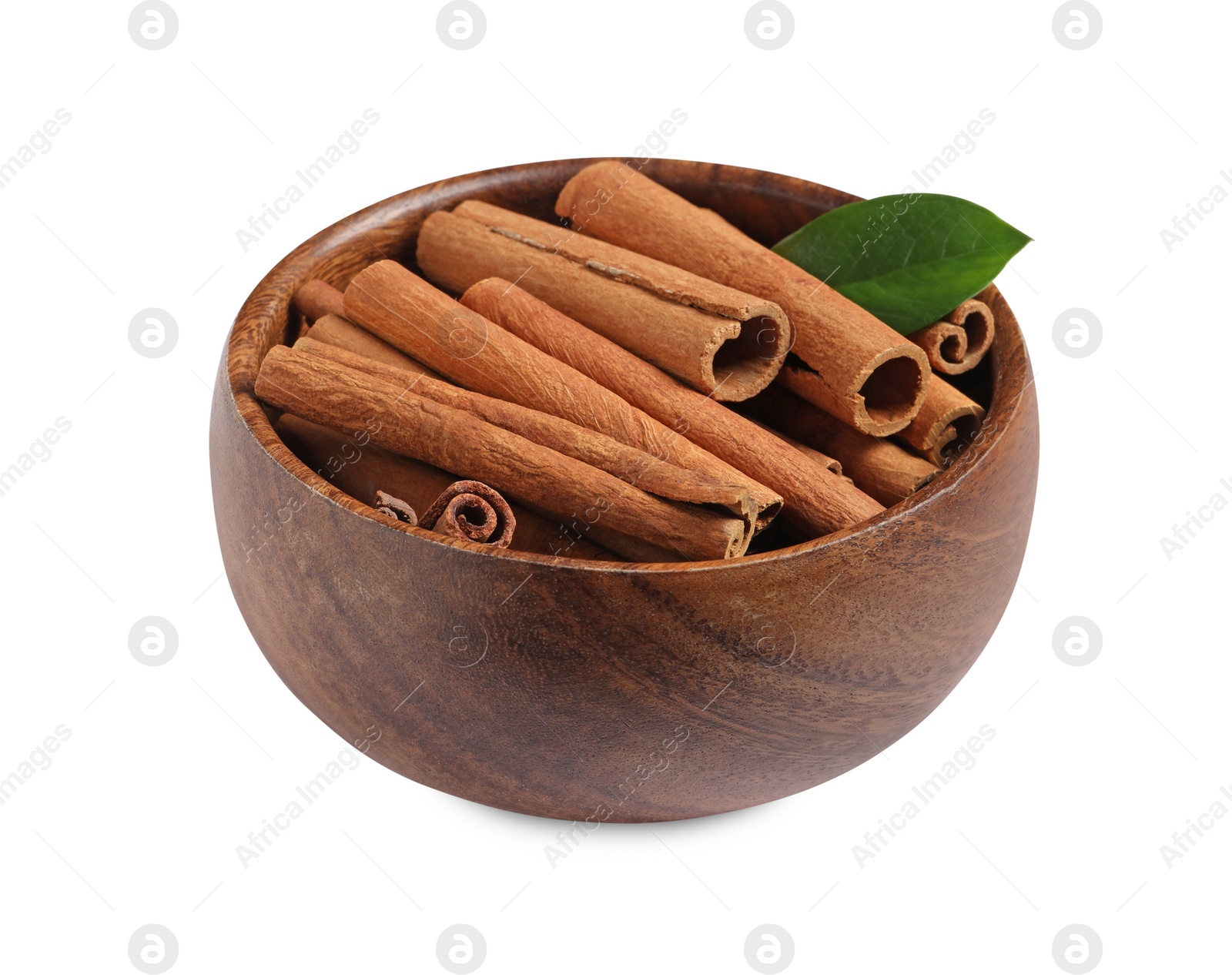 Photo of Cinnamon sticks and green leaf in bowl isolated on white