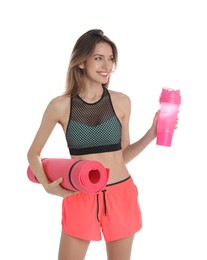 Beautiful woman with yoga mat and shaker on white background