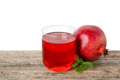 Photo of Refreshing pomegranate juice in glass, leaves and fruit on wooden table against white background. Space for text