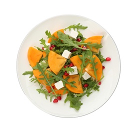 Photo of Delicious persimmon salad with pomegranate and arugula isolated on white, top view