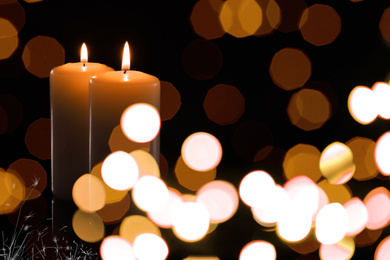 Image of Burning candles on dark background, bokeh effect