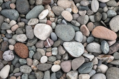 Many different pebbles as background, top view