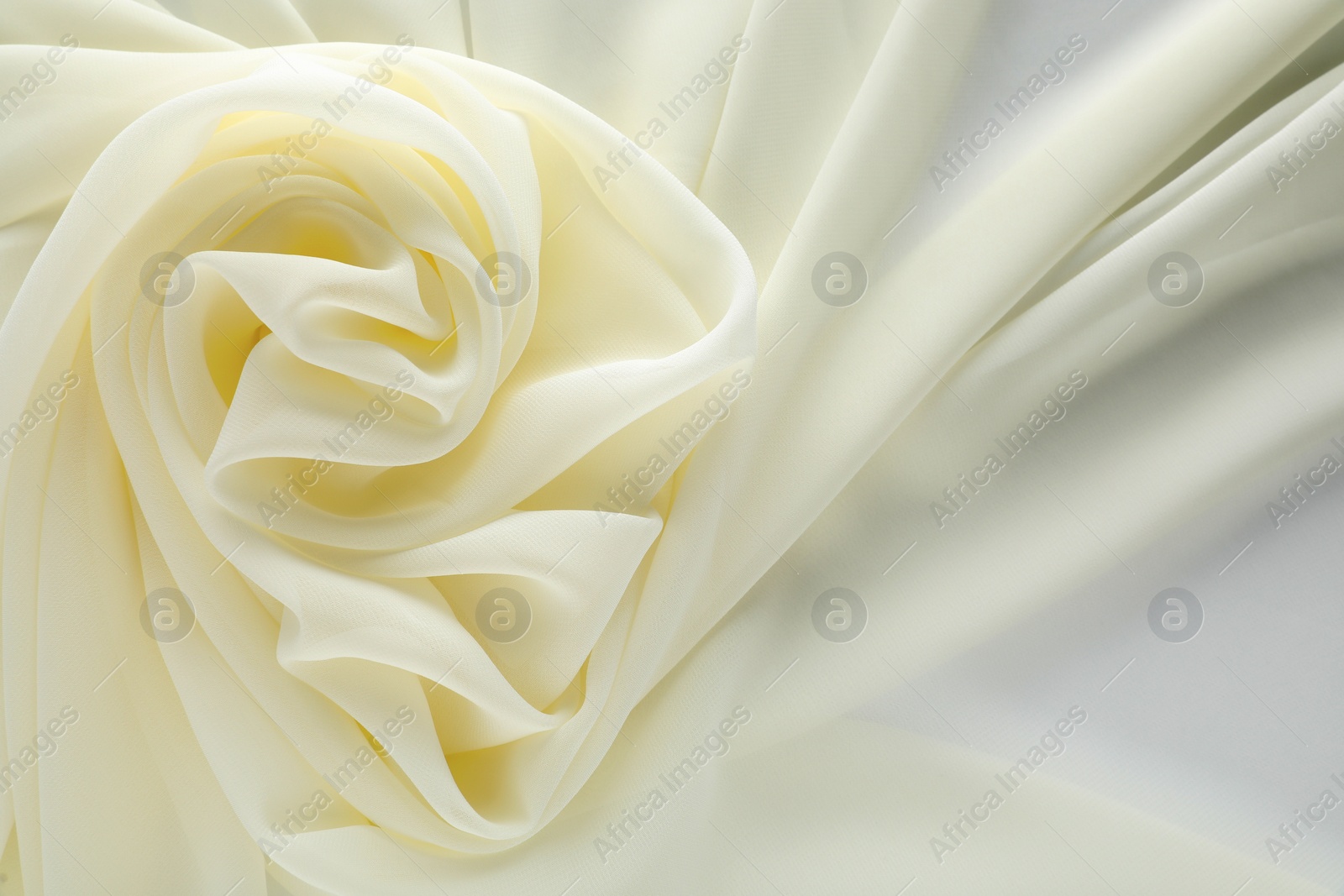 Photo of Beautiful white tulle fabric as background, top view