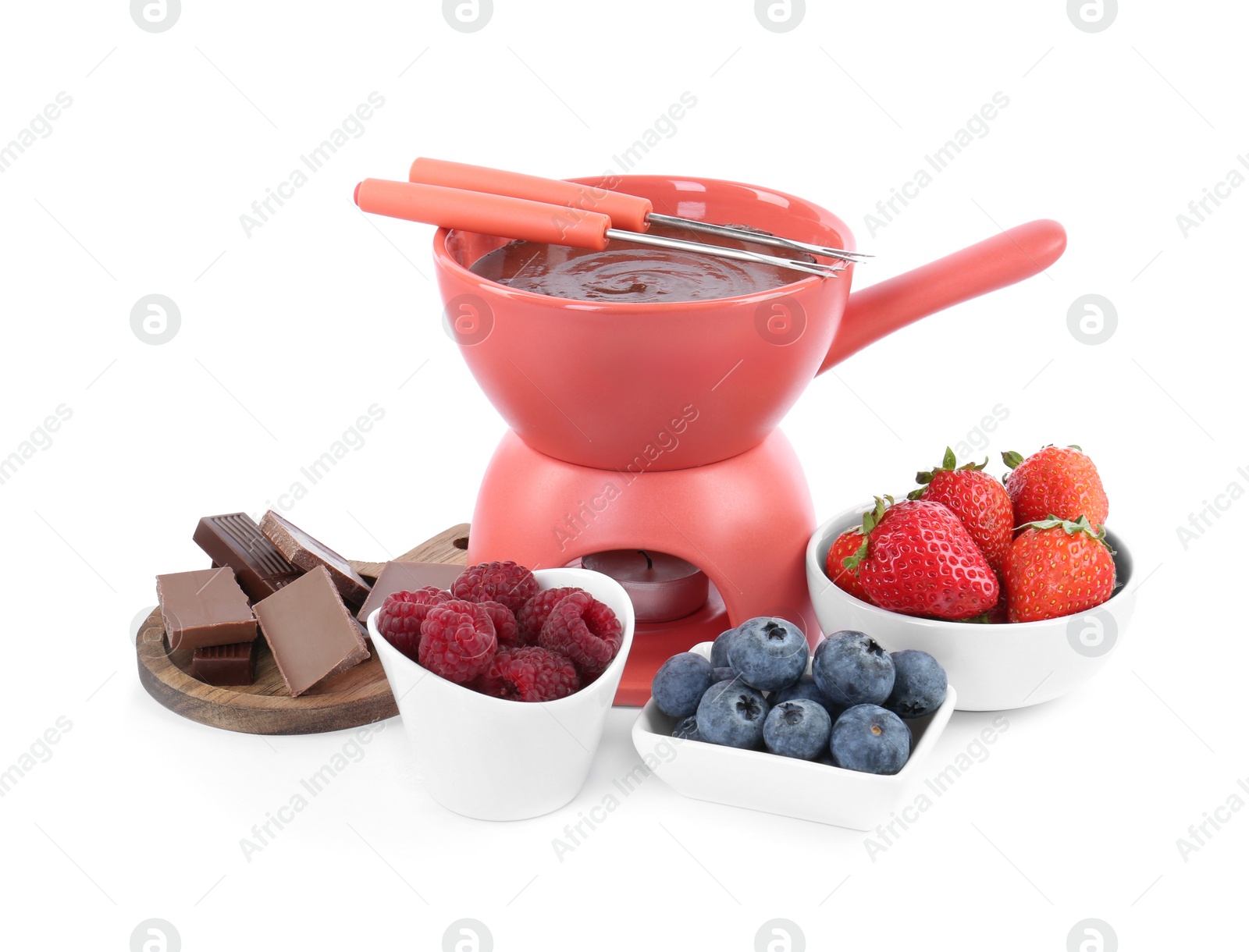 Photo of Fondue pot with melted chocolate, fresh berries and forks isolated on white