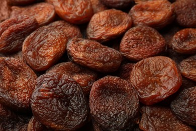 Tasty dried apricots as background, closeup. Healthy snack