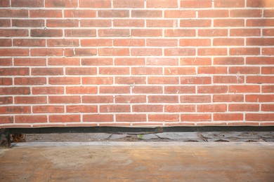 Photo of View on red brick wall and wooden floor