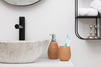 Photo of Different bath accessories, personal care products and bathroom vanity indoors