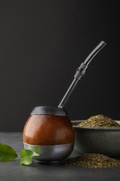 Photo of Calabash with mate tea and bombilla on light grey table