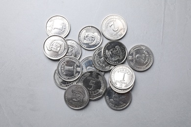 Photo of Ukrainian coins on grey background, flat lay