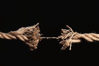 Photo of Rupture of cotton rope on black background