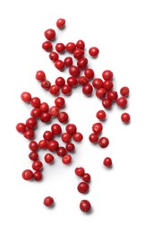 Photo of Aromatic spice. Many red peppercorns isolated on white, top view