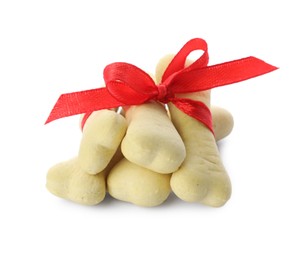 Photo of Bone shaped dog cookies with red bow on white background