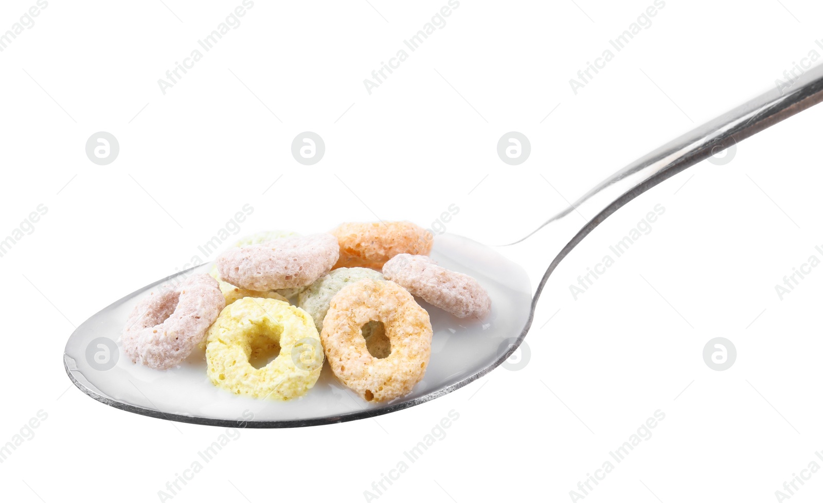 Photo of Cereal rings and milk in spoon isolated on white