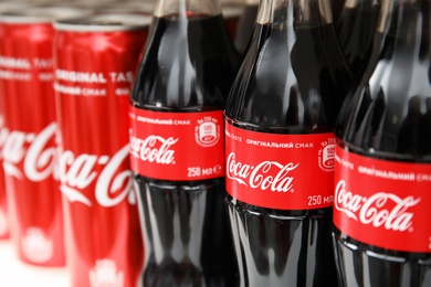 Photo of MYKOLAIV, UKRAINE - NOVEMBER 14, 2018: Coca-Cola cans and bottles on display in store