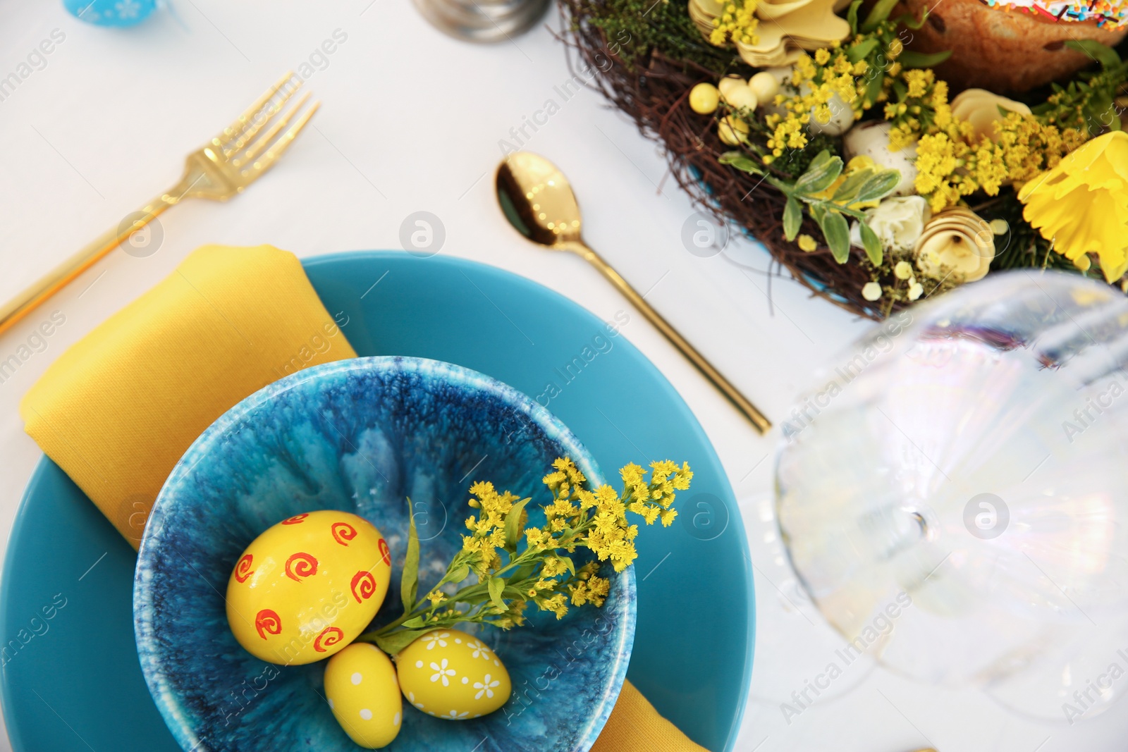 Photo of Festive Easter table setting with beautiful floral decor and eggs, above view