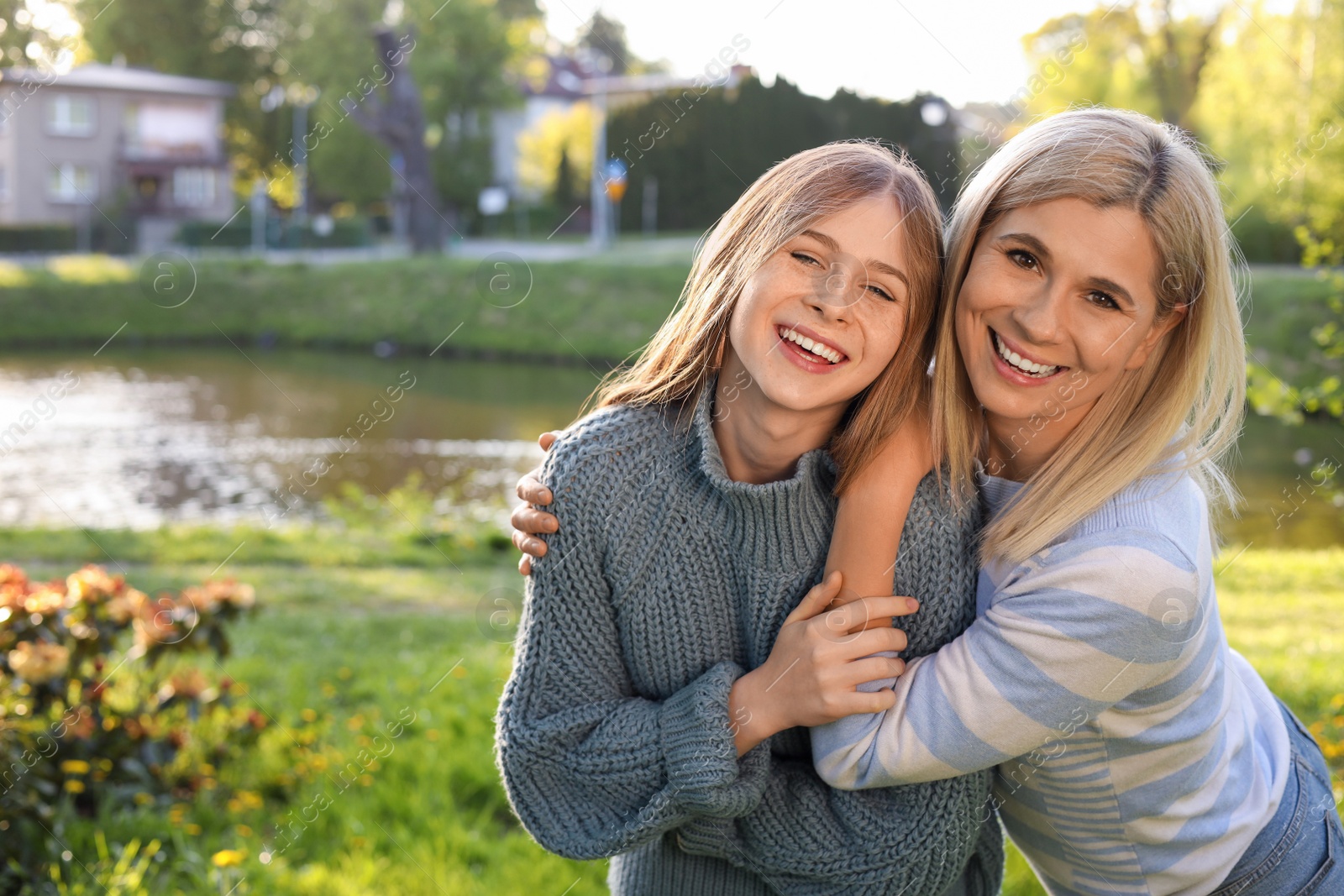 Photo of Happy mother with her daughter spending time together in park on sunny day