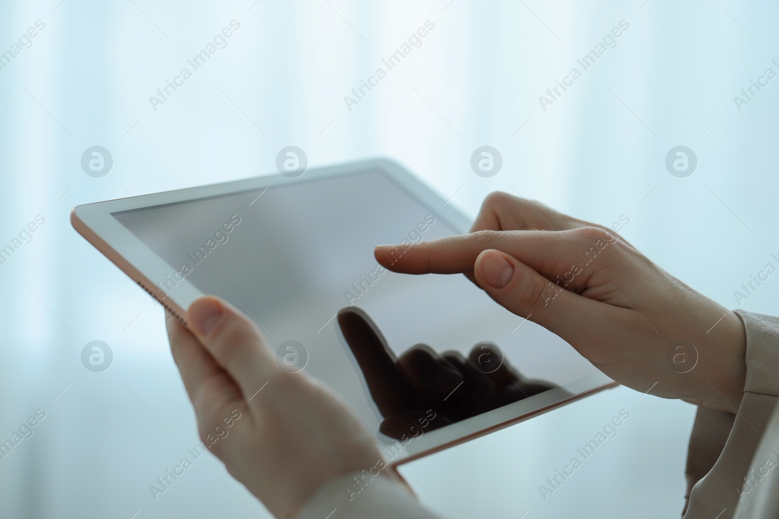 Photo of Closeup view of woman using modern tablet on blurred background