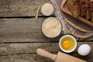 Photo of Flat lay composition with sourdough on wooden table. Space for text