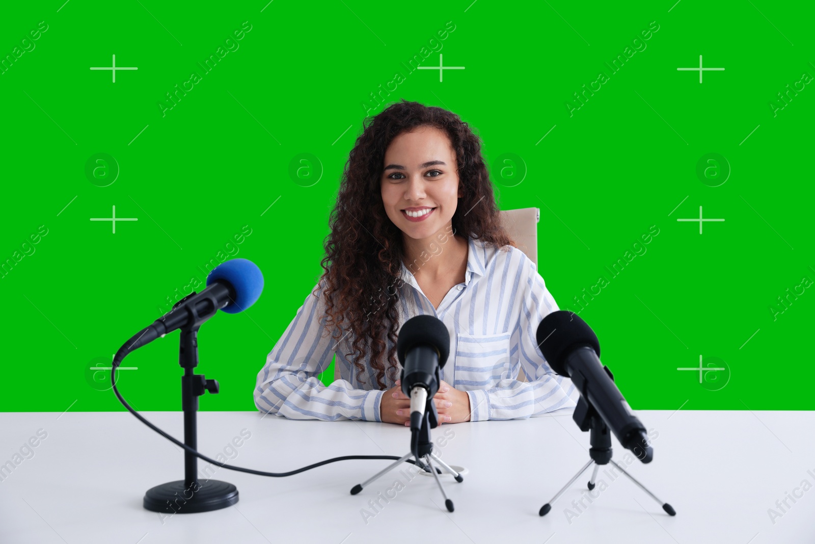 Image of Chroma key compositing. Woman giving interview during news conference. Green screen behind her