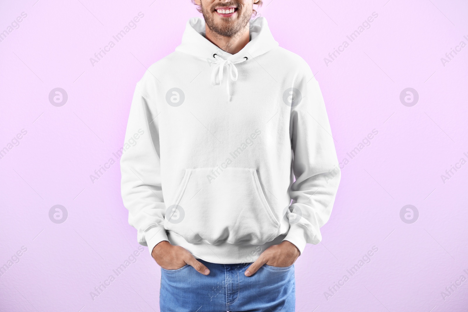 Photo of Man in hoodie sweater on color background. Space for design