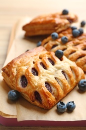 Fresh delicious puff pastry with fresh berries on table, closeup