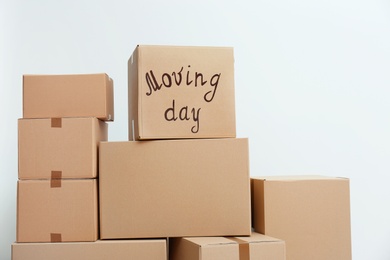 Photo of Pile of moving boxes on white background