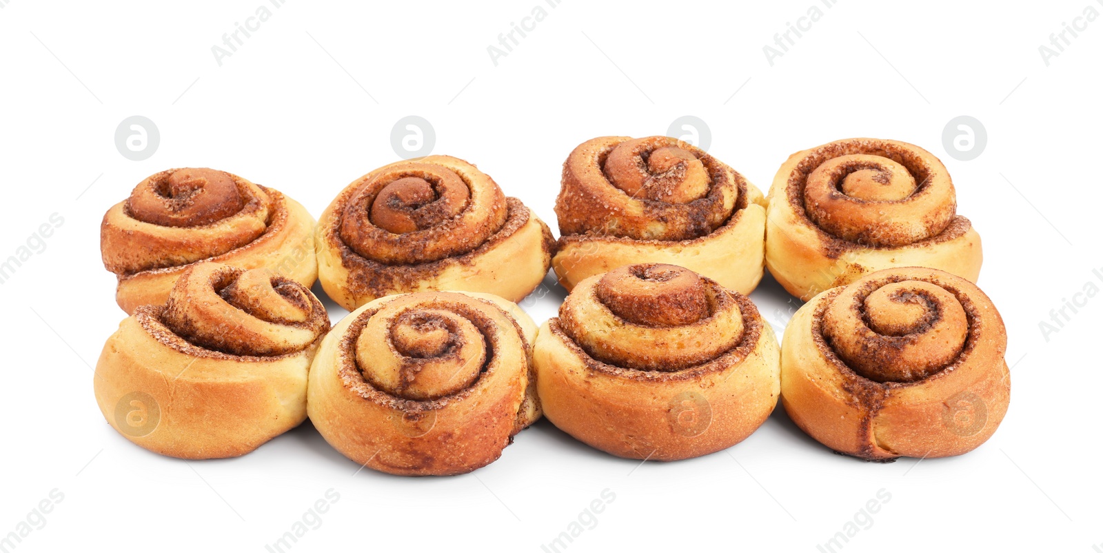 Photo of Many tasty cinnamon rolls isolated on white