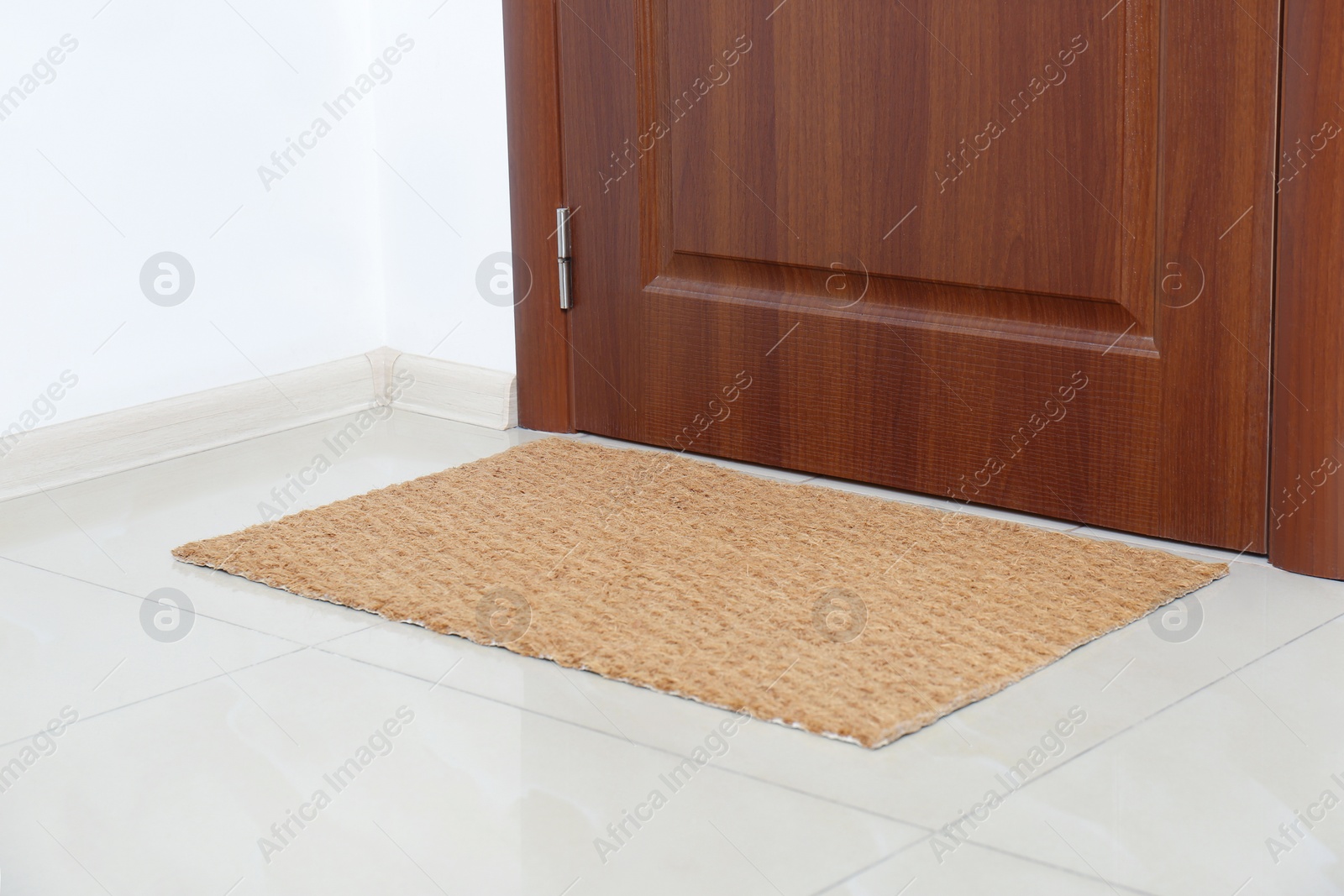 Photo of New clean mat near entrance door. Household item