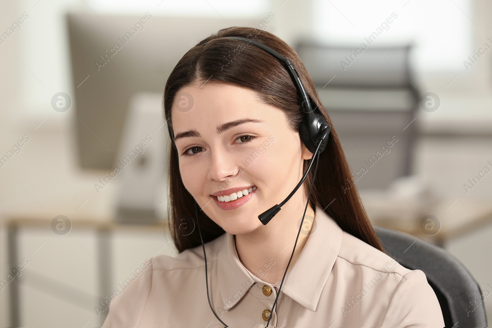 Photo of Hotline operator with headset working in office