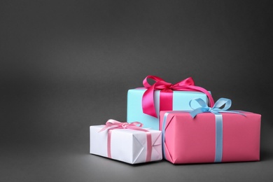 Photo of Beautiful gift boxes with ribbons on gray background