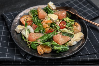 Delicious pomelo salad with shrimps served on table, closeup