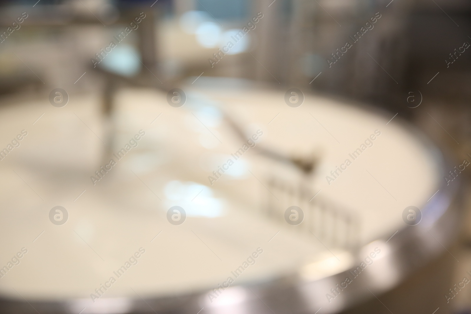 Photo of Blurred view of curd preparation tank with milk at cheese factory