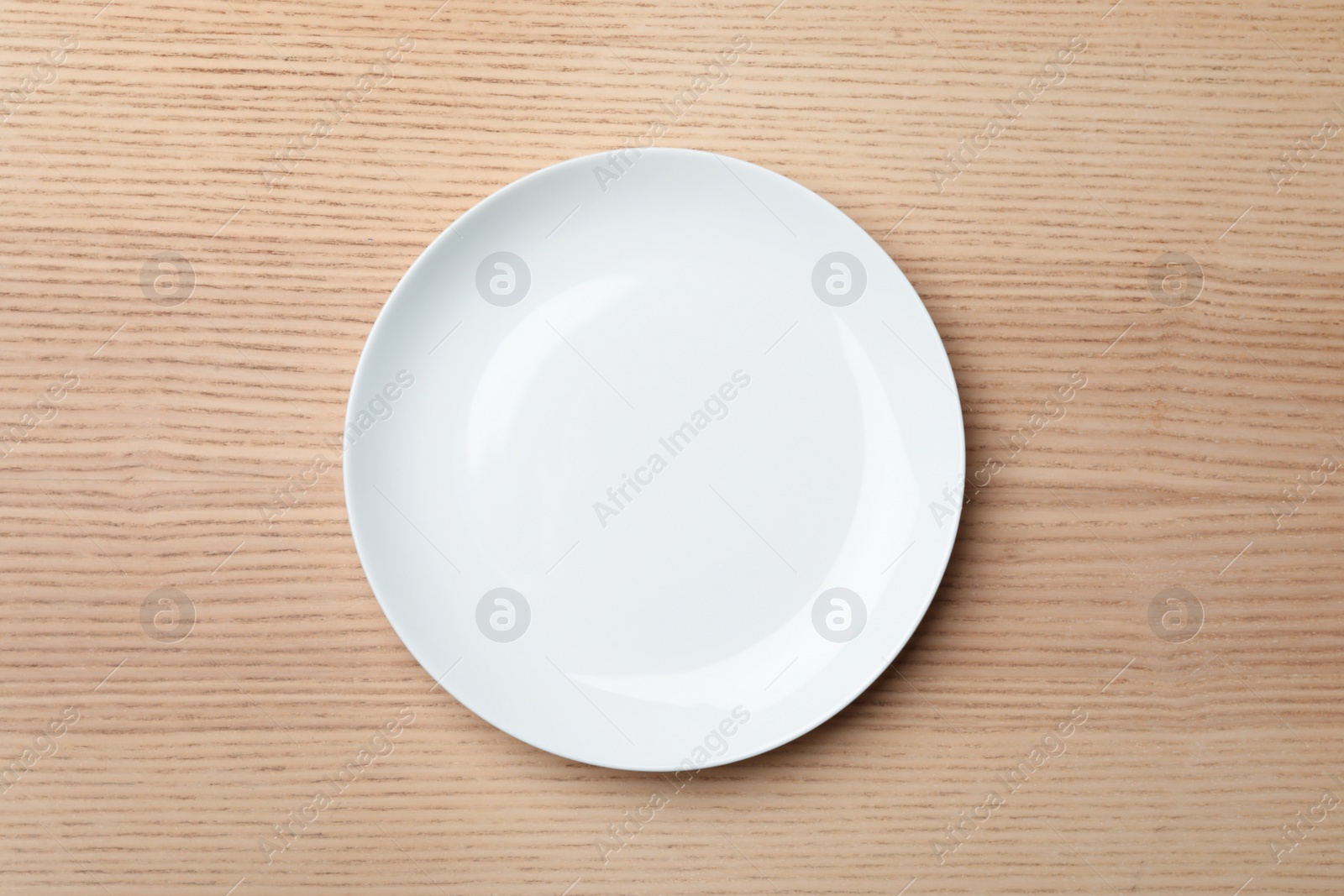 Photo of Stylish ceramic plate on wooden background, top view