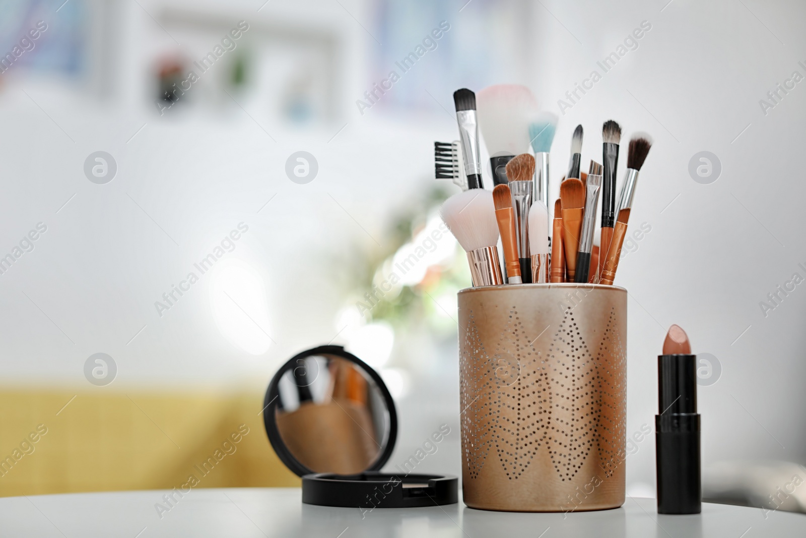 Photo of Holder with makeup brushes on table